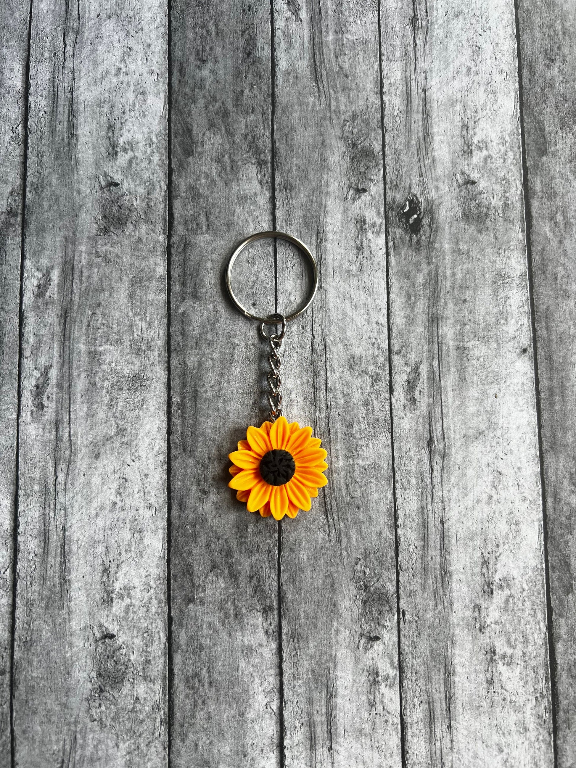 Sunflower is yellow with black middle. Sunflower is also made out of resin.