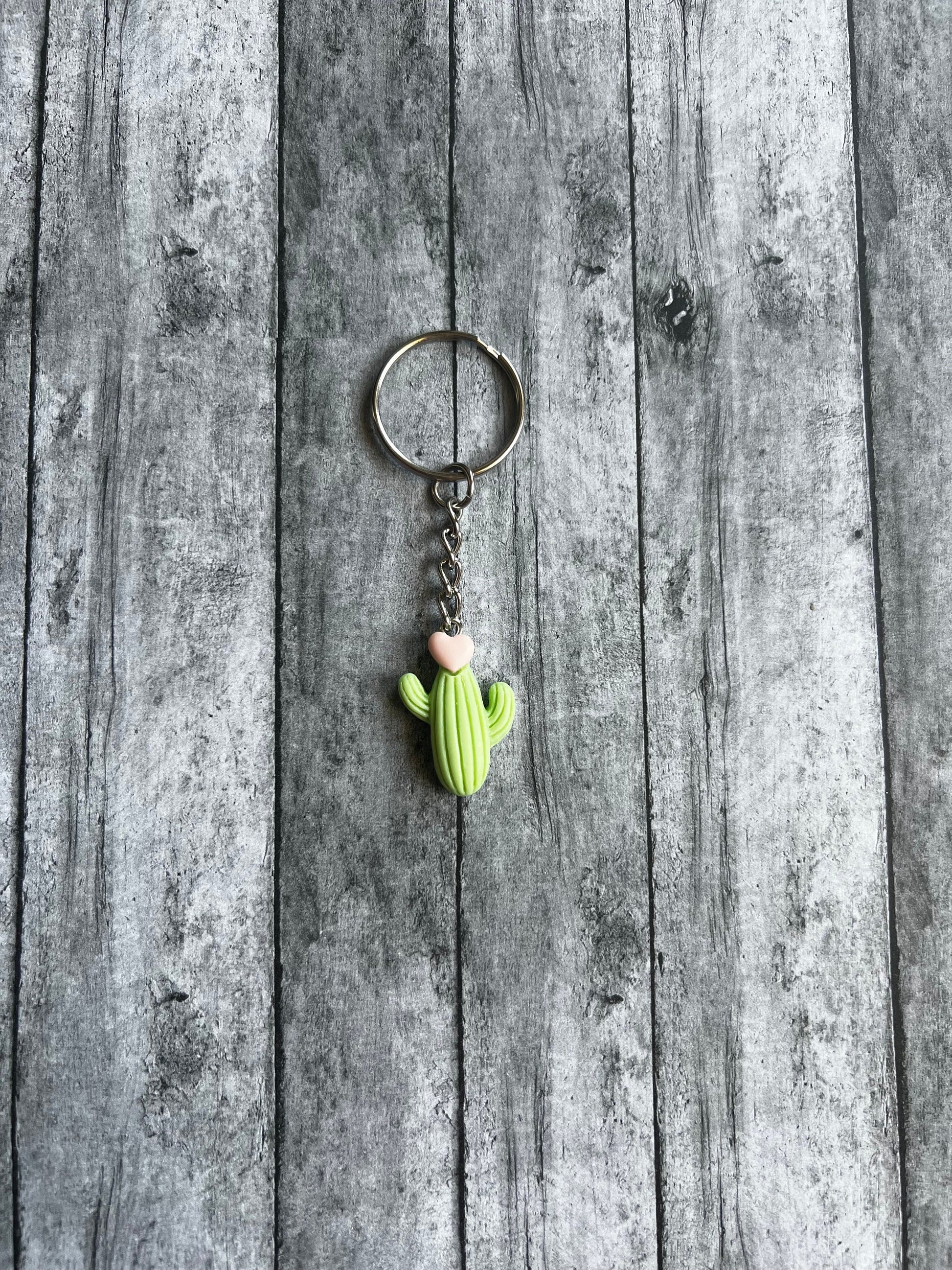 This cactus keychain is green with a light pink heart on the top. It would make as a very cute accent on your backpack, wristlet or etc.