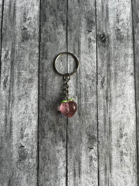 Cute, small pink peach keychain perfect to use as an accent piece for your wristlet, backpack, etc.